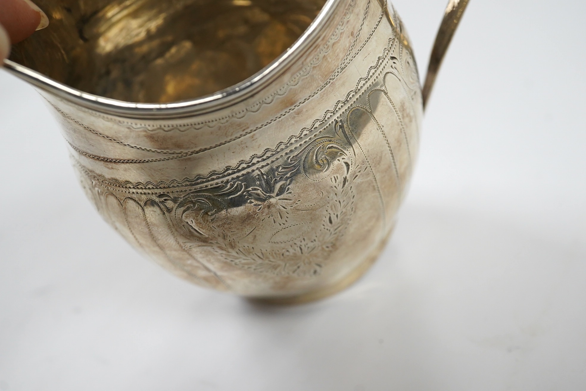 A George III engraved silver helmet shaped cream jug, London, 1801, 12.4cm, 3.4oz. Condition - poor